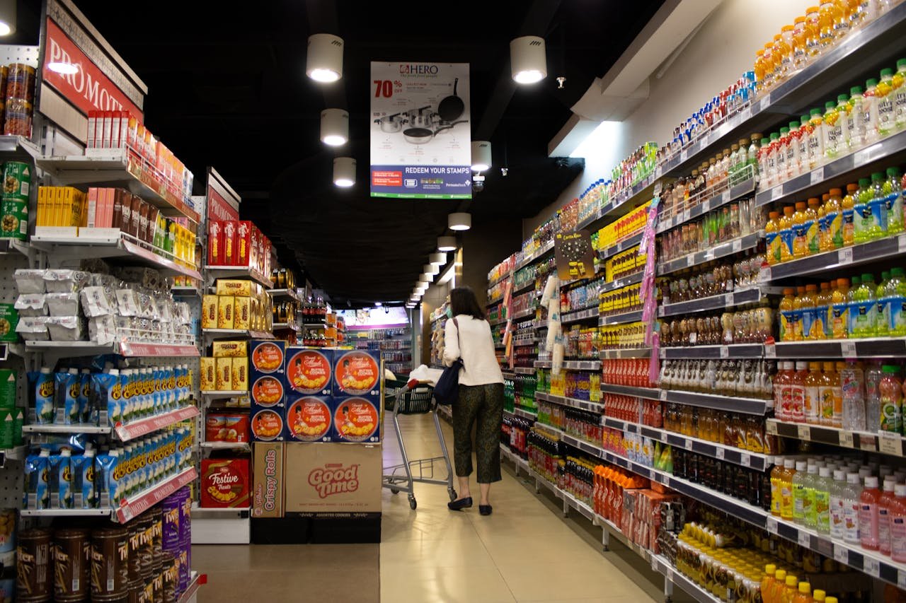 Vibrant supermarket aisle scene with a shopper in Jawa Timur, Indonesia.