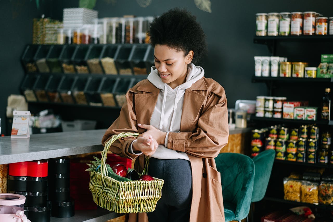 A pregnant woman shops for fresh vegetables at an organic grocery store.